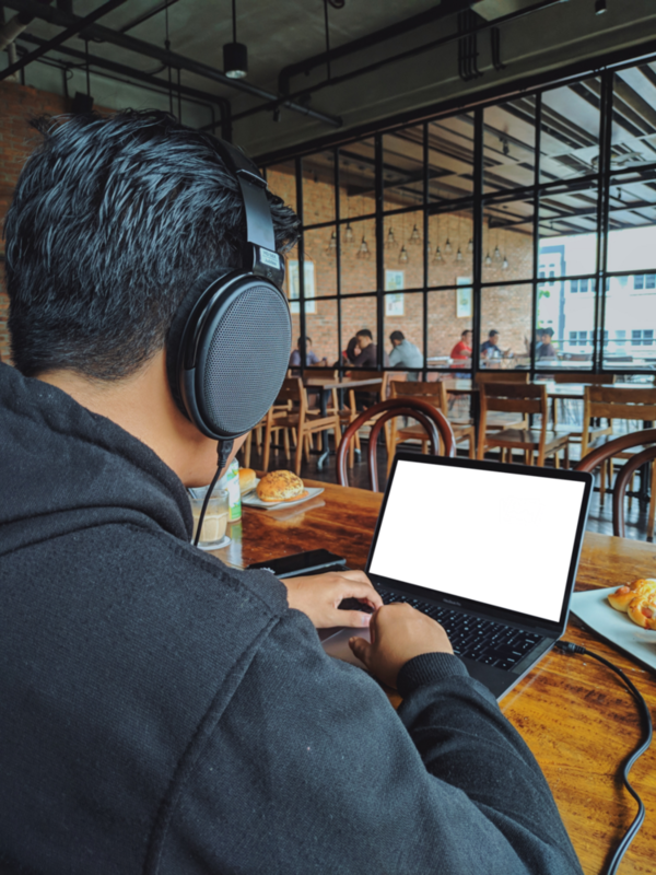 Laptop Mockup: person gaming in the coffee shop