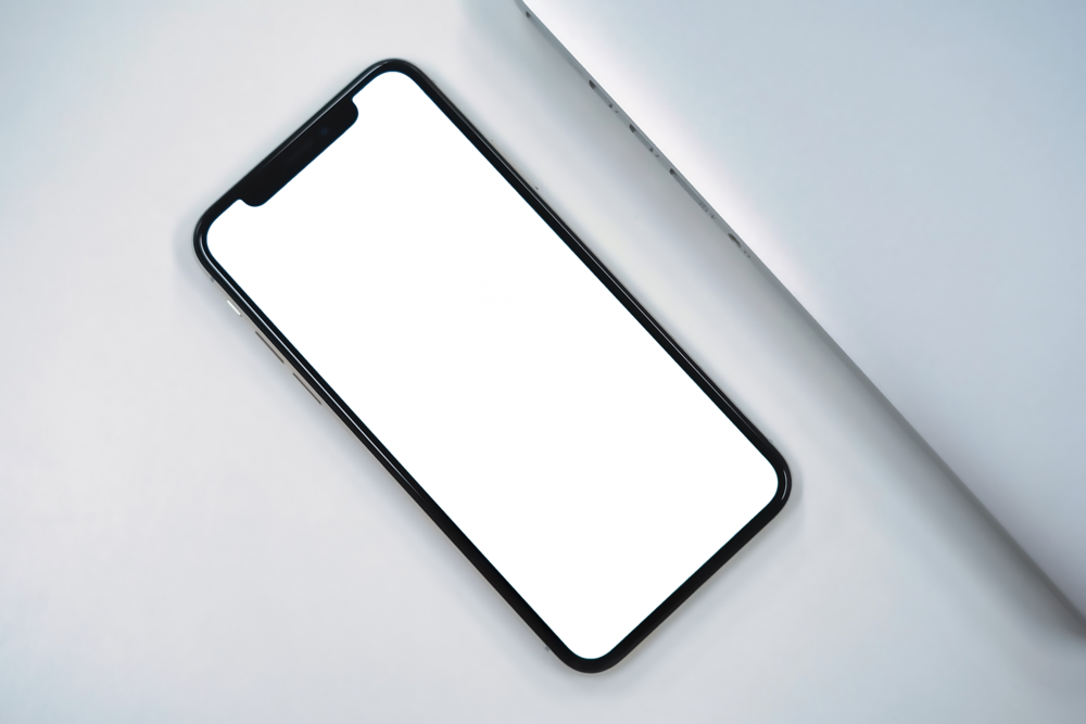 Mobile Mockup: iphone on a desk near macbook