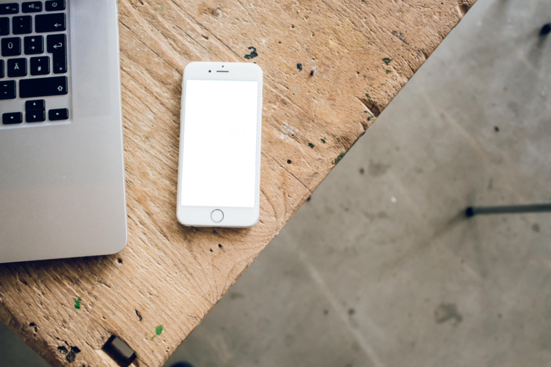 Mobile Mockup: iphone on the wooden desk near macbook